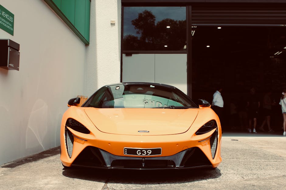 Stunning orange sports car showcased at showroom entry