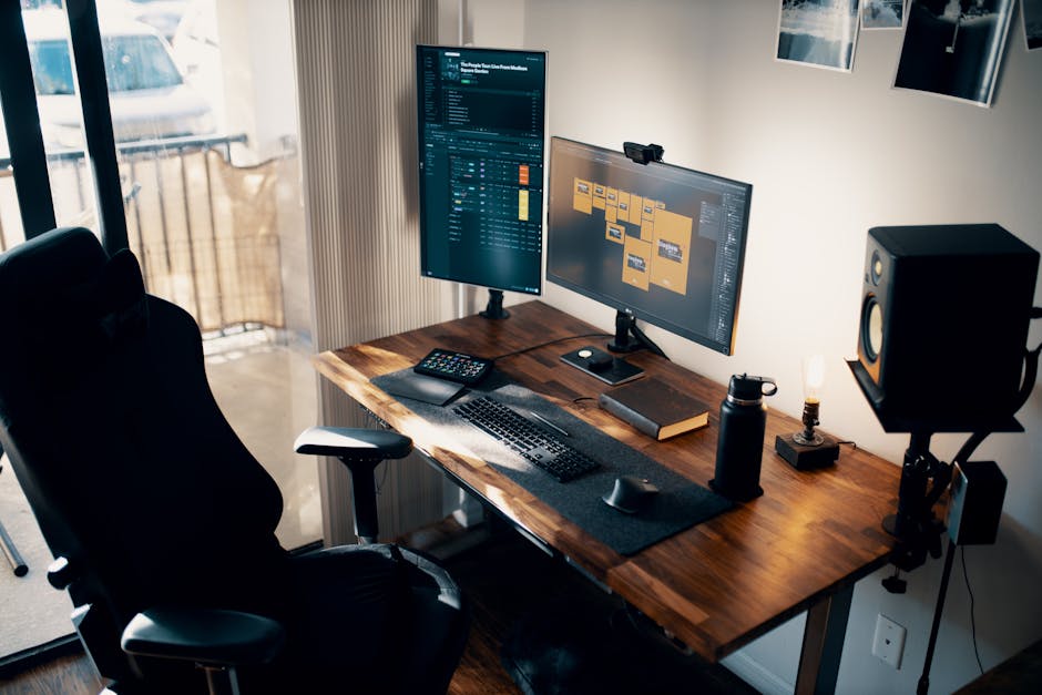 Contemporary office setup with dual monitors, ergonomic chair, and wooden desk